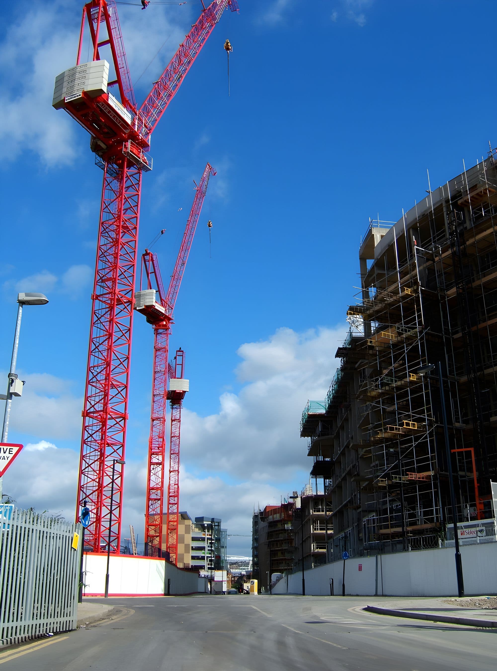 Tower cranes above a busy UK construction site