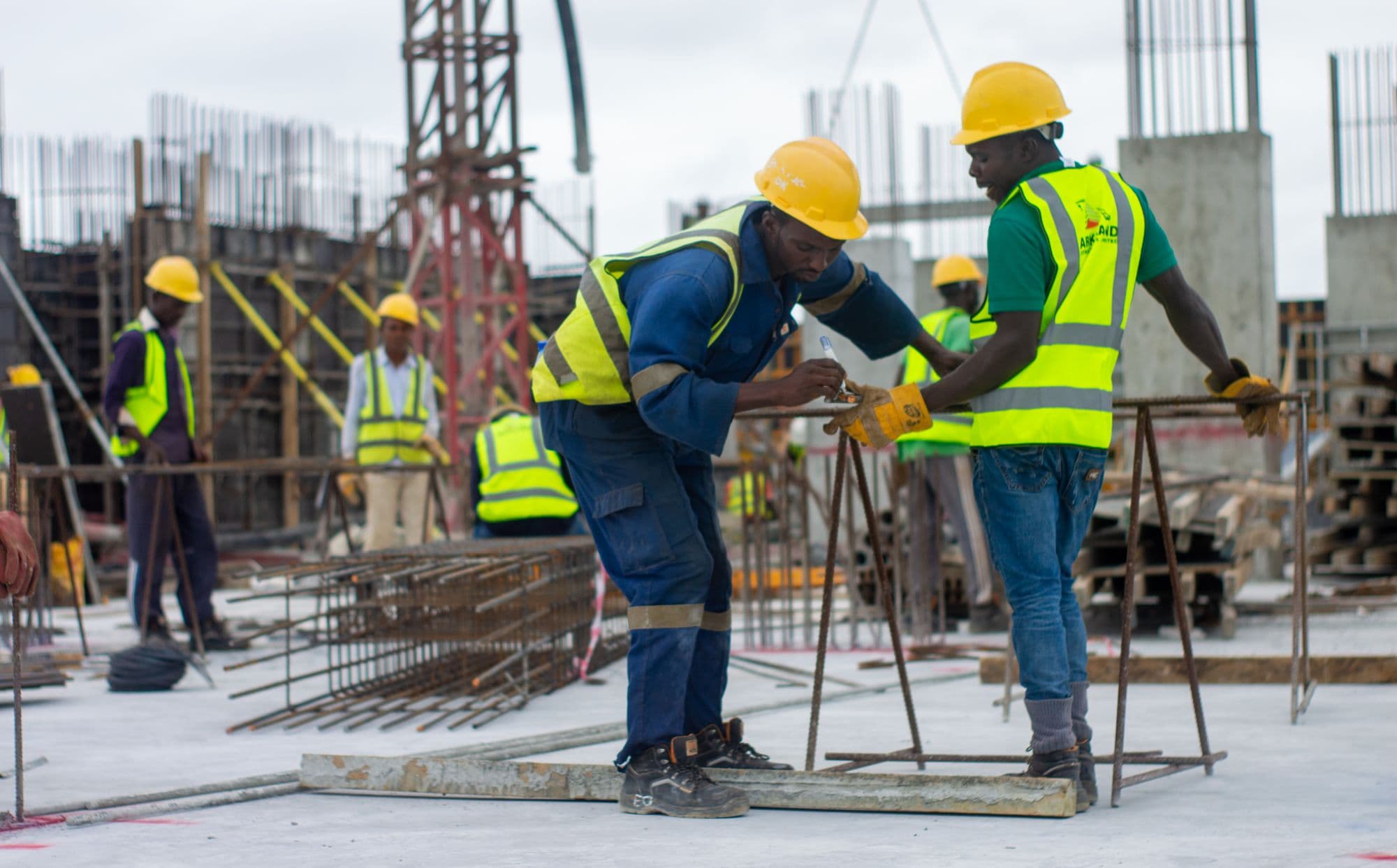 Skilled construction tradespeople working on a UK building site with Blue CSCS cards